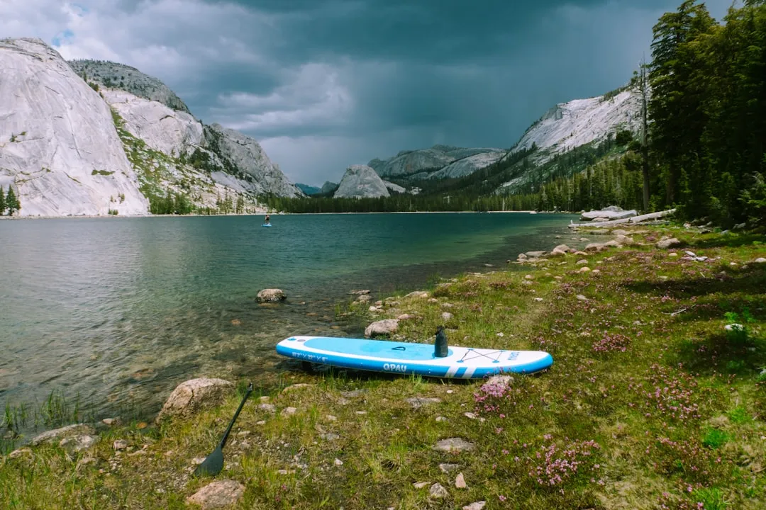 Two paddlers enjoying tandem inflatable kayak on calm lake