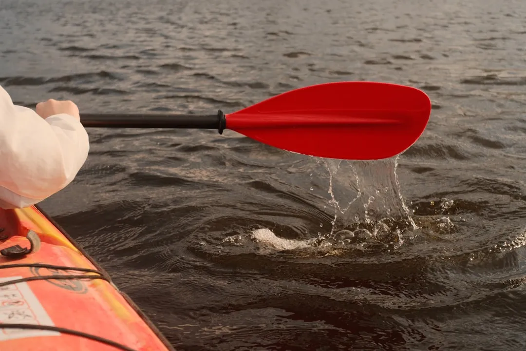 Kayaker preparing for kayak launch with paddle ready
