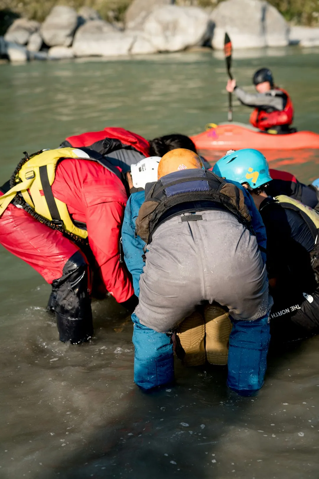 Kayaker preparing to launch on a cold morning with frost visible on the shoreline