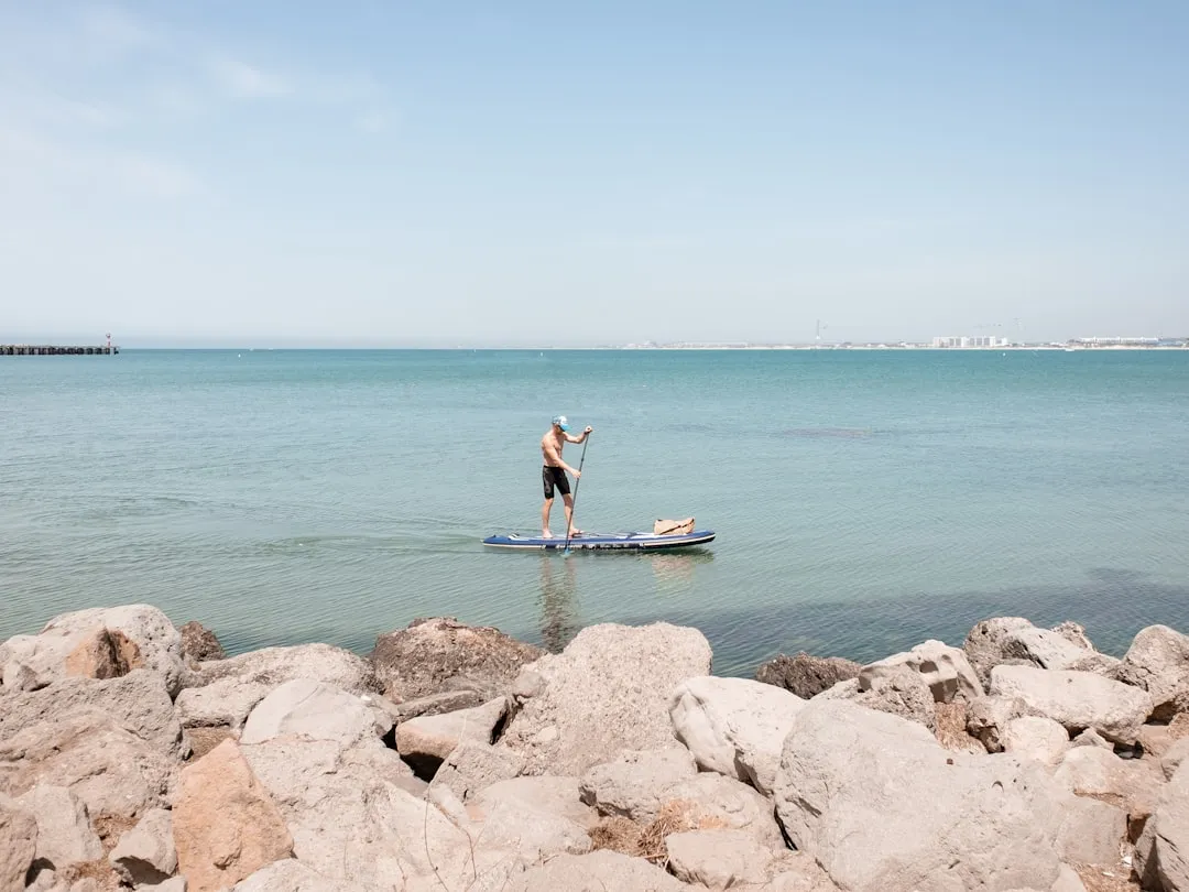Paddleboarder enjoying calm water after mastering basic skills