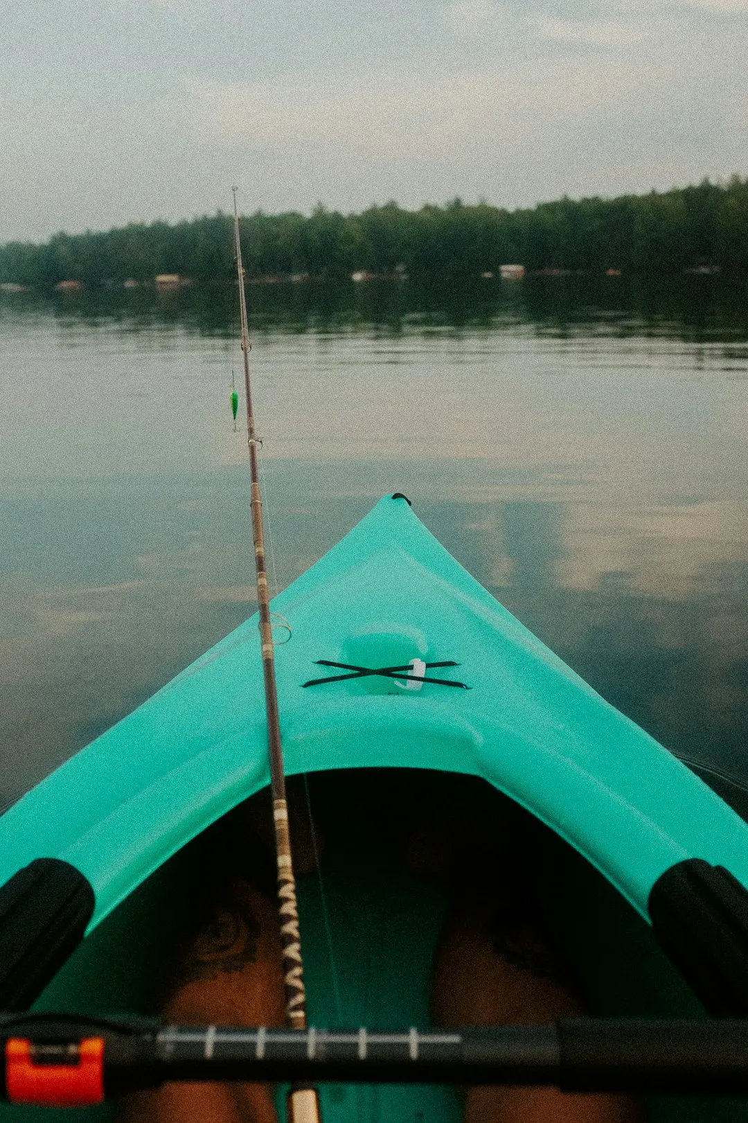 Kayak angler approaching fish quietly in shallow water