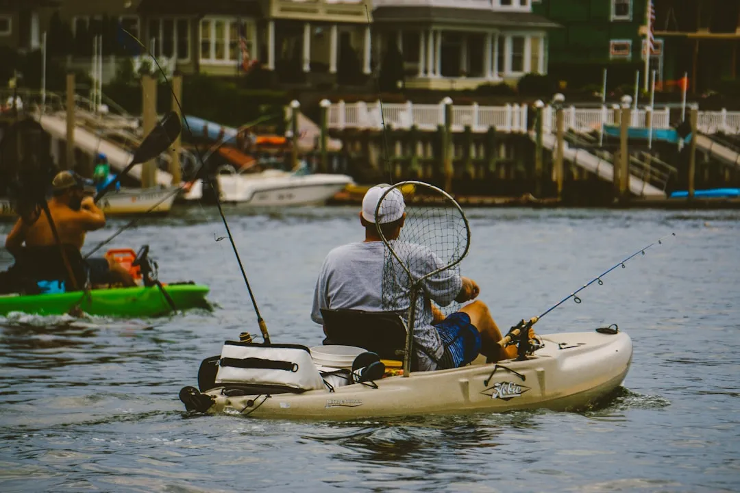 Essential kayak fishing gear laid out on a dock