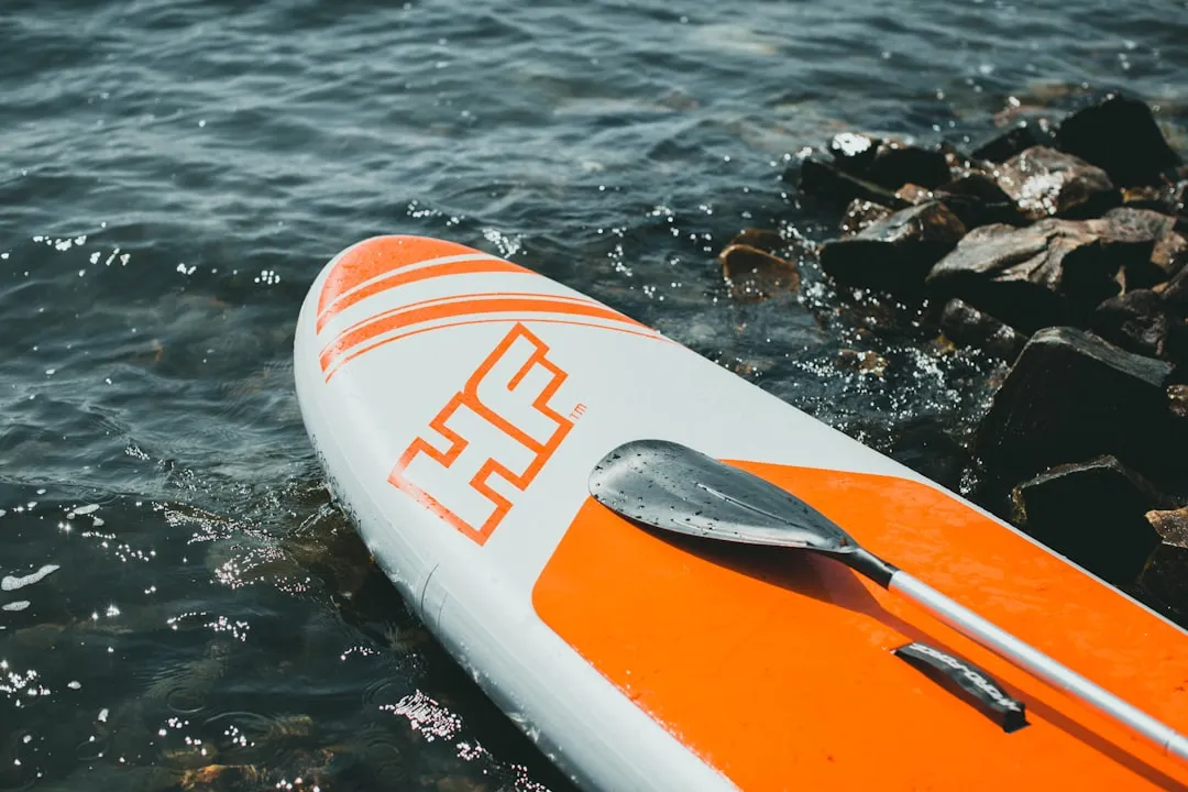 Woman paddle boarding on calm lake