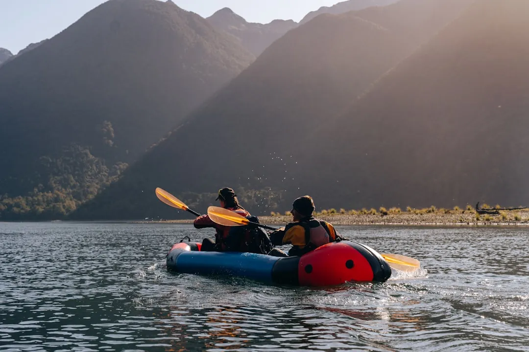 Kayaker navigating calm lake waters on inflatable kayak