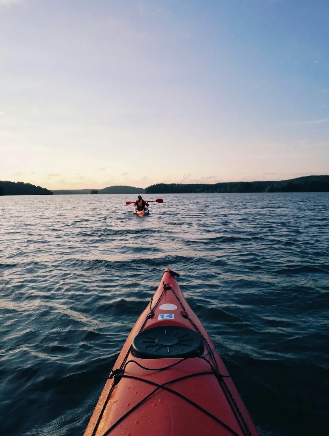 Lake kayaking on calm, sheltered waters demonstrating stable recreational boats