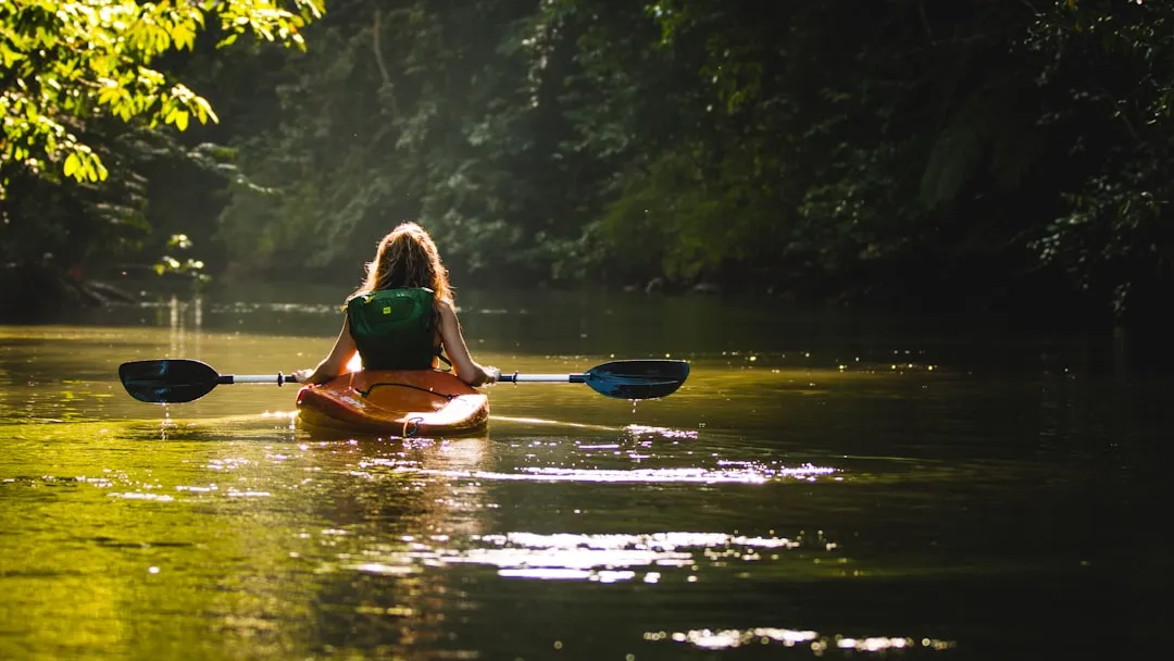 A kayak navigating through a scenic river canyon